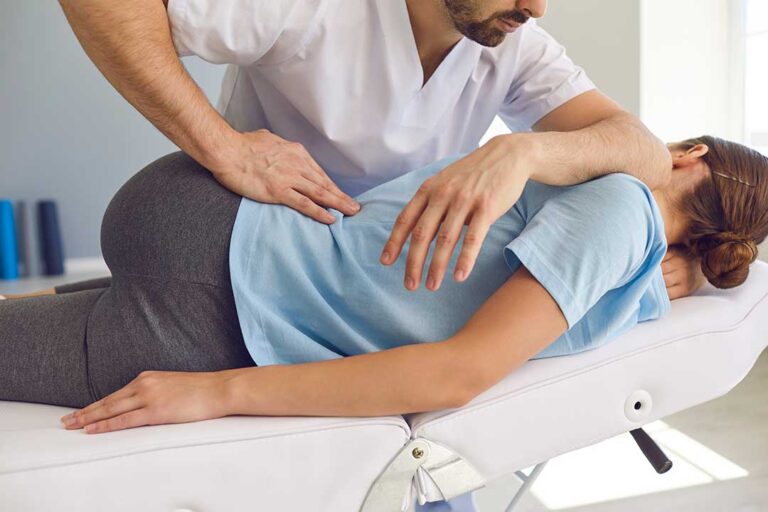 A person laying peacefully on their back in bed with a supportive pillow and relaxed posture.