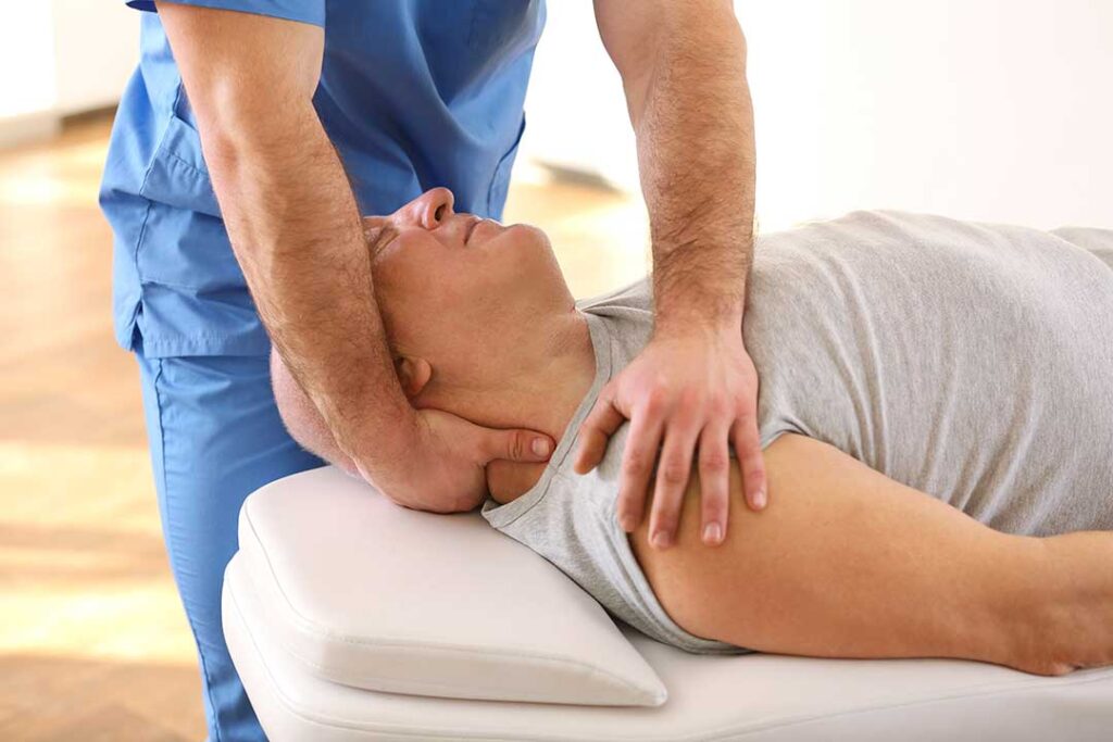 Person wearing a neutral wrist splint while doing gentle hand exercises at a home desk.